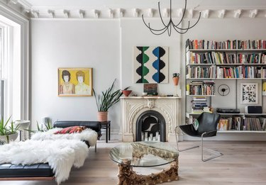 white living room with book display and curated artwork