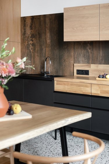 two-tone kitchen color idea with matte black and natural wood kitchen cabinetry