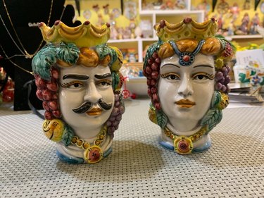 Two multicolored ceramic head figurines