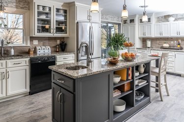 skinny kitchen island with sink, storage, and seating