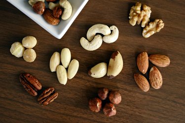 variety of nuts on wood surface