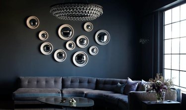 inky wall with white circular mirror display