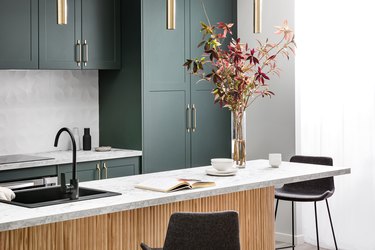 Kitchen with dark green cabinets