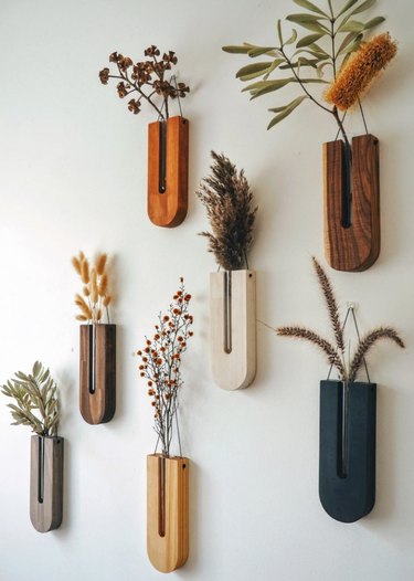 Wooden wall vases with dried flowers.