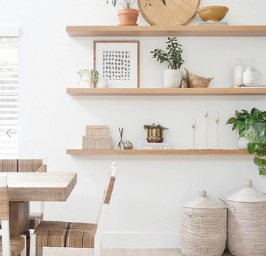 Floating shelves, plants, art, baskets, dining table and chairs.