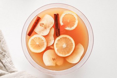 Garnish punch with cinnamon sticks, apple slices, and orange slices