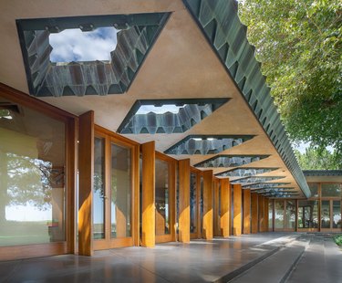 A geometric Frank Lloyd Wright house with many glass doors