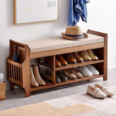bamboo storage bench with shoe racks and upholstered seat cushion
