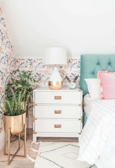 white nightstand in bedroom with slanted walls