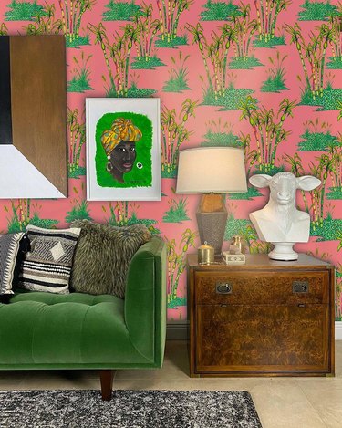 Living room with printed wallpaper and green sofa