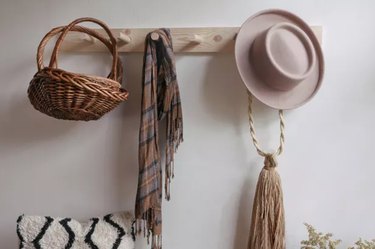 Wall hanger with basket, scarf and hat.