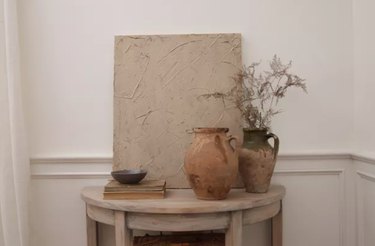 Textured canvas, vases, table.