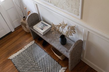 DIY limestone hypertufa bench in entryway with shoes and basket