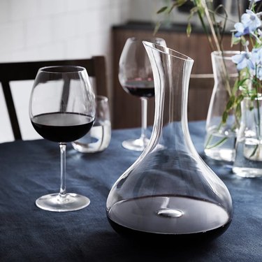 table with wine glasses and carafe with wine