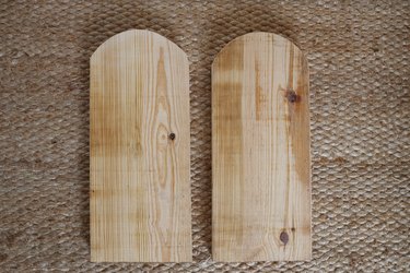 Two bench legs with rounded arch shape cut on top of each