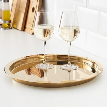gold tray with two wine glasses