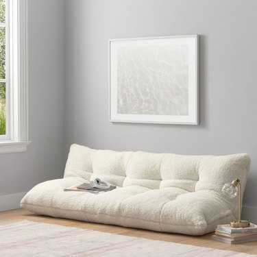 white tufted floor sofa