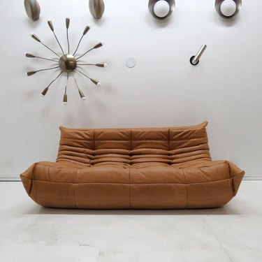 brown togo sofa with midcentury lighting