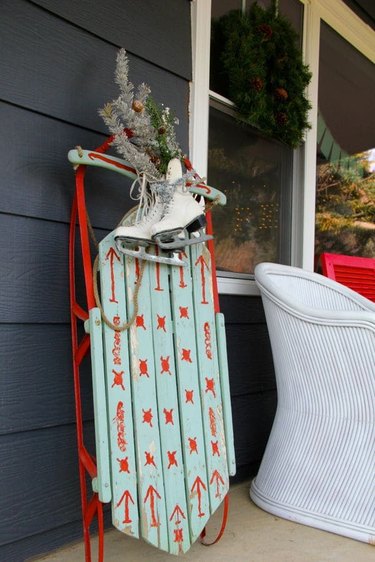 winter front porch with vintage sled