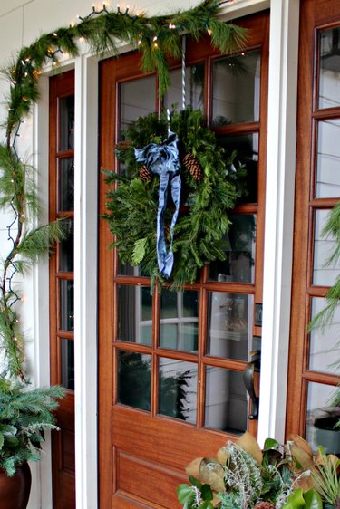 winter front porch with wreath on door