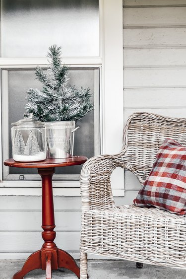 winter front porch with red table and white chair