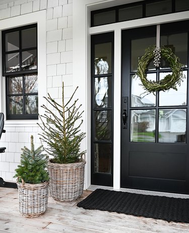 winter front porch with evergreens in baskets