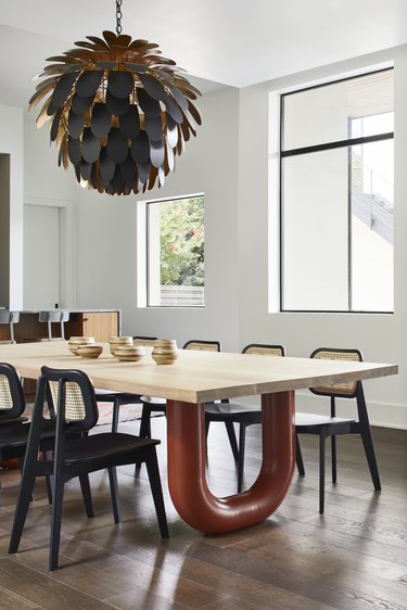 dining area with wood table and black-and-cane chairs