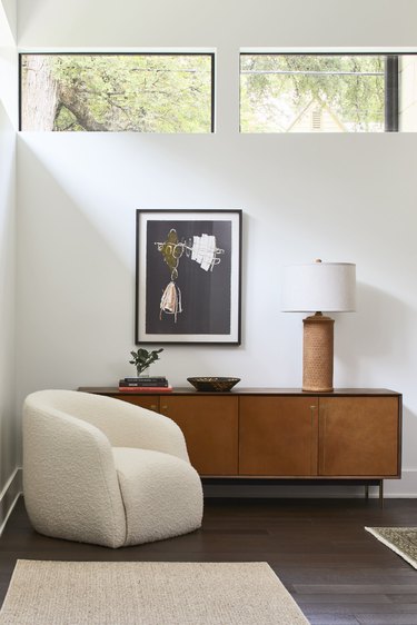 seating area with off-white chair near credenza