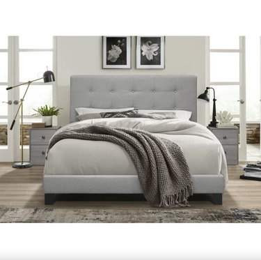 gray upholstered bed in bedroom