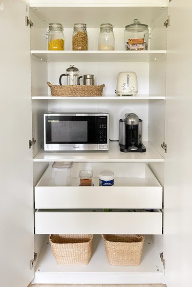 IKEA PAX pantry hack with jars of food, microwave, toaster, and coffee maker