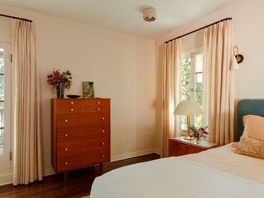 primary bedroom with peach colored walls and matching curtains