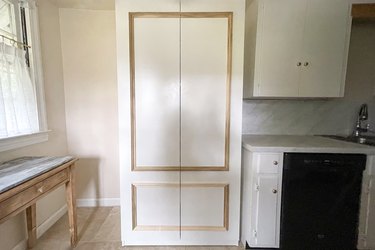 FORSAND doors with molding trim attached to IKEA PAX unit in kitchen