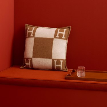 hermes pillow on red background