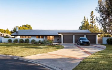 A ranch-style house with a roof that has solar shingles