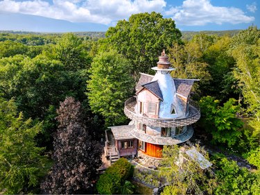 whimsical tower house amidst greenery