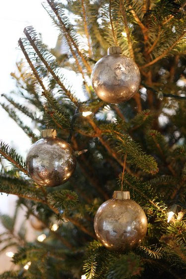 DIY mercury glass ornaments hanging from tree