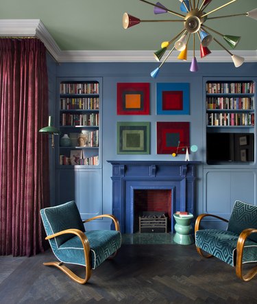 living room with light blue walls and darker blue fireplace surround