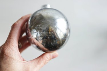 Several layers of dried mirror paint creating a mercury glass look inside ornament