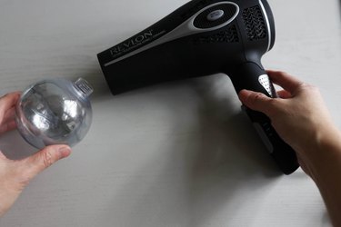 Blowing air into ornament with hair dryer