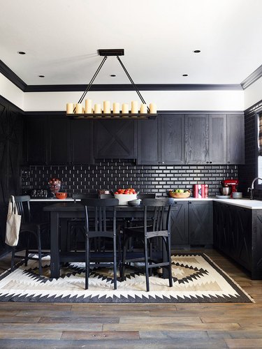 black kitchen island surrounded by black cabinets