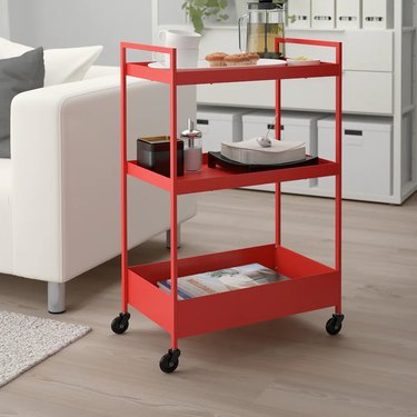 Red cart with 3 tiers in a living room