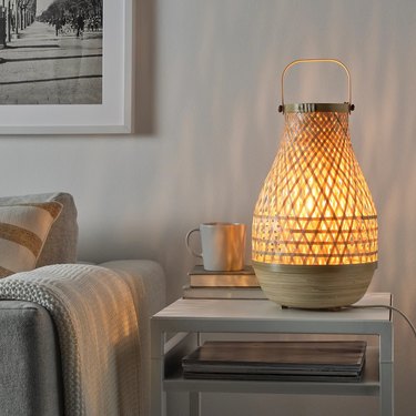 A bamboo table lamp on a side table