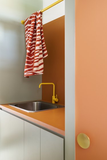 orange, light green, and yellow laundry room