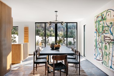 dining room with large glass door and painting
