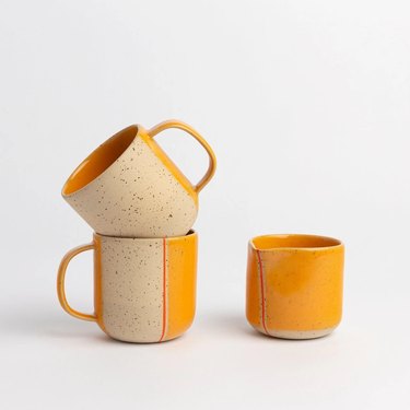 Yellow red and tan ceramic mugs