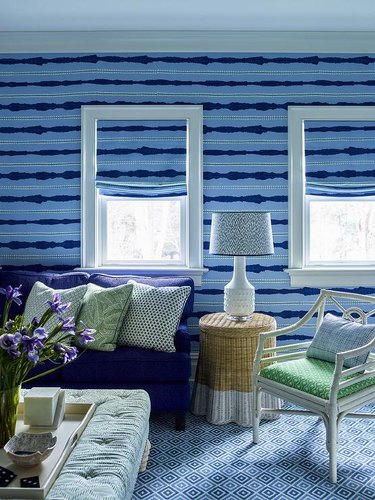living room with powder blue and navy blue striped wallpaper and window treatment