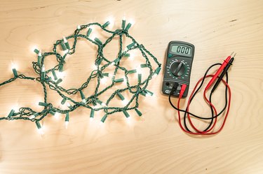 holiday lights illuminated with multimeter electrical tester