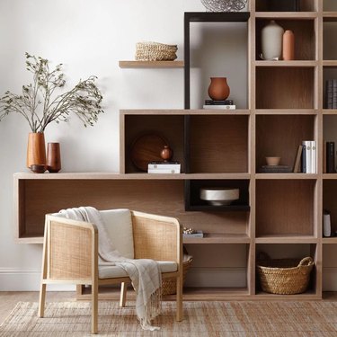 neutral living room with chair and shelving