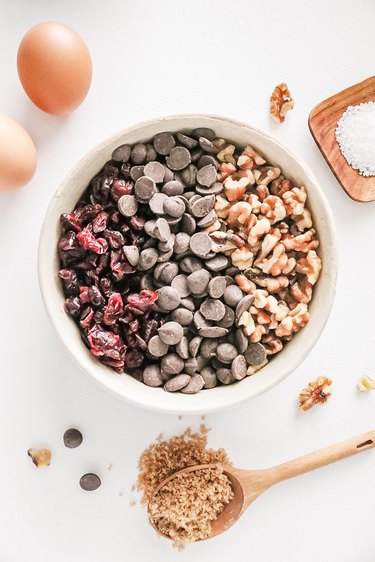 Dried cranberries, chocolate chips, and walnuts in a bowl