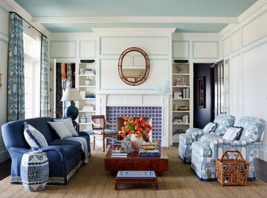 living room with blue tiled fireplace surround